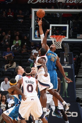 ATLANTA - OCTOBER 7: David West #30 of the New Orleans Hornets deflects a shot by Frank Robinson #14 of the Atlanta Hawks during a preseason game on October 7, 2009 at Philips Arena in Atlanta, Georgia.  <br /><br /><span class="help">(Photo by Scott Cunningham/NBAE via Getty Images)</span>