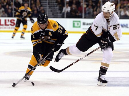 BOSTON - OCTOBER 08:  Patrice Bergeron #37 of the Boston Bruins takes the puck from Scott Niedermayer #27 of the Anaheim Ducks on October 8, 2009 at the TD Garden in Boston, Massachusetts. The Ducks defeated the Bruins 6-1.  <br /><br /><span class="help">(Photo by Elsa/Getty Images)</span>