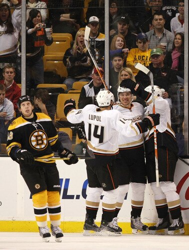 BOSTON - OCTOBER 08: Evgeny Artyukhin #24 of the Anaheim Ducks is congratulated by teammate Joffrey Lupul #14 as Matt Hunwick #48 of the Boston Bruins looks up a the scoreboard on October 8, 2009 at the TD Garden in Boston, Massachusetts. The Ducks defeated the Bruins 6-1.  <br /><br /><span class="help">(Photo by Elsa/Getty Images)</span>