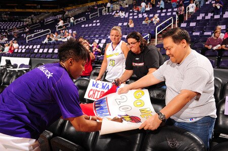 PHOENIX - OCTOBER 9: Cappie Pondexter #23 of the Phoenix Mercury autographs a fan's sign as the Mercury host the Indiana Fever in Game five of the WNBA Finals played on October 9, 2009 at U.S. Airways Center in Phoenix, Arizona. <br /><br /><span class="help">(Photo by Barry Gossage/NBAE via Getty Images)</span>