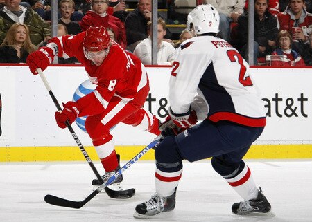 DETROIT - OCTOBER 10: Justin Abdelkader #8 of the Detroit Red Wings looks to get a shot off past Brian Pothier #2 of the Washington Capitals on October 10, 2009 at Joe Louis Arena in Detroit, Michigan. <br /><br /><span class="help">(Photo by Gregory Shamus/Getty Images)</span>
