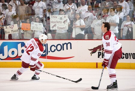 GLENDALE, AZ - OCTOBER 10:  Fans hold up signs as Paul Bissonnette #12 and Vernon Fiddler #38 of the Phoenix Coyotes warm up before the NHL game against the Columbus Blue Jackets at Jobing.com Arena on October 10, 2009 in Glendale, Arizona.  <br /><br /><span class="help">(Photo by Christian Petersen/Getty Images)</span>