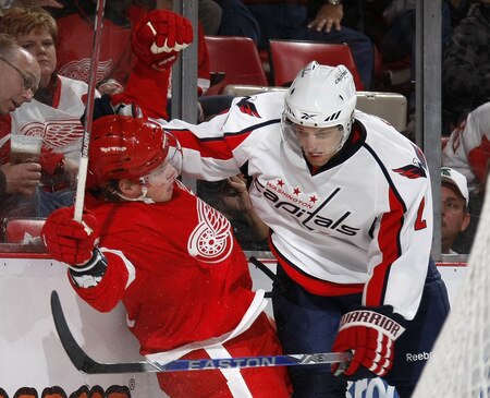 DETROIT - OCTOBER 10: Brian Pothier #2 of the Washington Capitals lays a check on Justin Abdelkader #8 of the Detroit Red Wings on October 10, 2009 at Joe Louis Arena in Detroit, Michigan. <br /><br /><span class="help">(Photo by Gregory Shamus/Getty Images)</span>