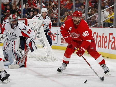 DETROIT - OCTOBER 10: Henrik Zetterberg #40 of the Detroit Red Wings looks for a open teammate in front of Jose Theodore #60 of the Washington Capitals on October 10, 2009 at Joe Louis Arena in Detroit, Michigan. <br /><br /><span class="help">(Photo by Gregory Shamus/Getty Images)</span>