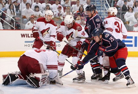 GLENDALE, AZ - OCTOBER 10:  Sami Lepisto #18 of the Phoenix Coyotes attempts to clear out Samuel Pahlsson #26 and Derek Dorsett #15 of the Columbus Blue Jackets as goaltender Ilya Bryzgalov #30 covers the puck during the NHL game at Jobing.com Arena on October 10, 2009 in Glendale, Arizona.  <br /><br /><span class="help">(Photo by Christian Petersen/Getty Images)</span>
