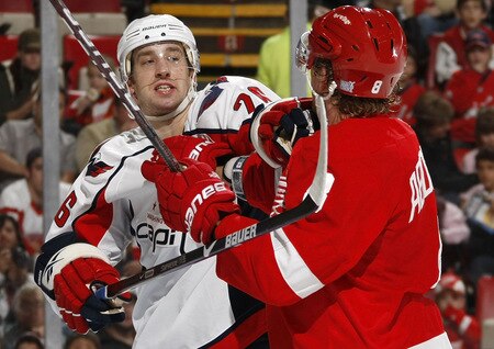 DETROIT - OCTOBER 10: Shaone Morrisonn #26 of the Washington Capitals gets in a shoving match with Justin Abdelkader #8 of the Detroit Red Wings on October 10, 2009 at Joe Louis Arena in Detroit, Michigan. <br /><br /><span class="help">(Photo by Gregory Shamus/Getty Images)</span>