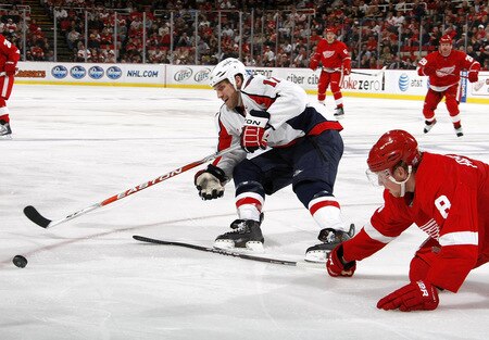 DETROIT - OCTOBER 10: Chris Clark #17 of the Washington Capitalstries to get around the stick of Justin Abdelkader #8 of the Detroit Red Wings on October 10, 2009 at Joe Louis Arena in Detroit, Michigan. <br /><br /><span class="help">(Photo by Gregory Shamus/Getty Images)</span>
