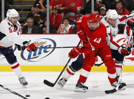 DETROIT - OCTOBER 10:  Pavel Datsyuk #13 of the Detroit Red Wings tries to get around the stick of Mike Green #52 of the Washington Capitals on October 10, 2009 at Joe Louis Arena in Detroit, Michigan. <br /><br /><span class="help">(Photo by Gregory Shamus/Getty Images)</span>