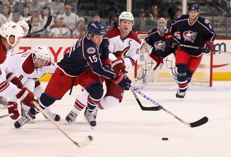 GLENDALE, AZ - OCTOBER 10:  Derek Dorsett #15 of the Columbus Blue Jackets skates after the puck under pressure from Shane Doan #19 of the Phoenix Coyotes during the NHL game at Jobing.com Arena on October 10, 2009 in Glendale, Arizona. The Blue Jackets defeated the Coyotes 2-0. <br /><br /><span class="help">(Photo by Christian Petersen/Getty Images)</span>