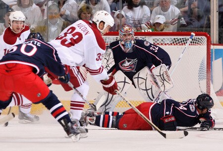 GLENDALE, AZ - OCTOBER 10:  Goaltender Mathieu Garon #32 of the Columbus Blue Jackets protects the net as Adrian Aucoin #33 of the Phoenix Coyotes skates in with the puck during the NHL game at Jobing.com Arena on October 10, 2009 in Glendale, Arizona. The Blue Jackets defeated the Coyotes 2-0. <br /><br /><span class="help">(Photo by Christian Petersen/Getty Images)</span>