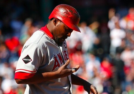 BOSTON - OCTOBER 11:  Vladimir Guerrero #27 of the Los Angeles Angels of Anaheim looks down at his hand after breaking his bat on a groundout to second base in the first inning against the Boston Red Sox in Game Three of the ALDS during the 2009 MLB Playoffs at Fenway Park on October 11, 2009 in Boston, Massachusetts. <br /><br /><span class="help">(Photo by Jim Rogash/Getty Images)</span>