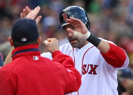 BOSTON - OCTOBER 11:  Mike Lowell #25 of the Boston Red Sox celebrates with teammates after scoring a run on a J.D. Drew #7 two-run home run in the fourth inning against the Los Angeles Angels of Anaheim in Game Three of the ALDS during the 2009 MLB Playoffs at Fenway Park on October 11, 2009 in Boston,  Massachusetts. <br /><br /><span class="help">(Photo by Jim Rogash/Getty Images)</span>