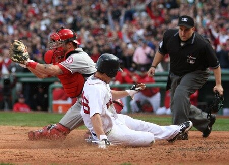 BOSTON - OCTOBER 11 Jacoby Ellsbury #46 of the Boston Red Sox scores over catcher Mike Napoli #44 of the Los Angeles Angels of Anaheim on a RBI double by Dustin Pedroia #15 in the third inning of Game Three of the ALDS during the 2009 MLB Playoffs at Fenway Park on October 11, 2009 in Boston, Massachusetts. <br /><br /><span class="help">(Photo by Elsa/Getty Images)</span>