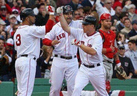BOSTON - OCTOBER 11:  (2nd R) J.D. Drew #7 of the Boston Red Sox celebrates with teammates (L) Alex Gonzalez #3 and Mike Lowell #25 as (R) Mike Napoli #44 of the Los Angeles Angels of Anaheim looks on after Drew's two-run home run in the fourth inning of Game Three of the ALDS during the 2009 MLB Playoffs at Fenway Park on October 11, 2009 in Boston,  Massachusetts. <br /><br /><span class="help">(Photo by Jim Rogash/Getty Images)</span>