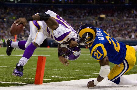 ST. LOUIS, MO - OCTOBER 11: Adrian Peterson #28 of the Minnesota Vikings scores a touchdown against Oshiomogho Atogwe #21 of the St. Louis Rams at the Edward Jones Dome on October 11, 2009 in St. Louis, Missouri.  <br /><br /><span class="help">(Photo by Dilip Vishwanat/Getty Images)</span>