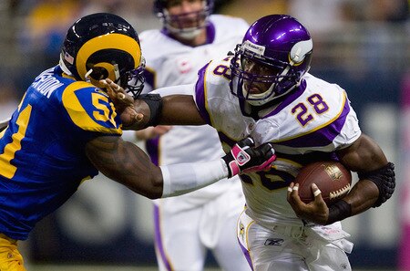 ST. LOUIS, MO - OCTOBER 11: Adrian Peterson #28 of the Minnesota Vikings looks to get past Will Witherspoon #51 of the St. Louis Rams at the Edward Jones Dome on October 11, 2009 in St. Louis, Missouri.  <br /><br /><span class="help">(Photo by Dilip Vishwanat/Getty Images)</span>