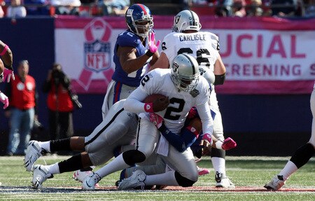 EAST RUTHERFORD, NJ - OCTOBER 11:  JaMarcus Russell #2 of the Oakland Raiders is sacked by Michael Johnson #20 of the New York Giants on October 11, 2009 at Giants Stadium in East Rutherford, New Jersey.  <br /><br /><span class="help">(Photo by Jim McIsaac/Getty Images)</span>