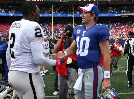 EAST RUTHERFORD, NJ - OCTOBER 11:  Eli Manning #10 of the New York Giants shakes hands with JaMarcus Russell #2 of the Oakland Raiders after their game on October 11, 2009 at Giants Stadium in East Rutherford, New Jersey. The Giants defeated the Raiders 44-7.  <br /><br /><span class="help">(Photo by Jim McIsaac/Getty Images)</span>