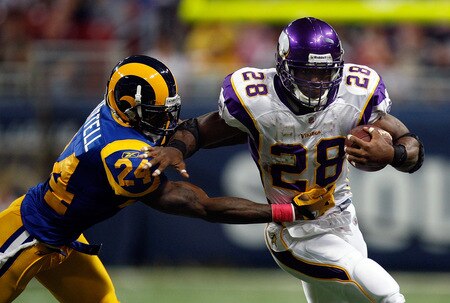 ST. LOUIS - OCTOBER 11:  Running back Adrian Peterson #28 of the Minnesota Vikings runs the ball past Ron Bartell #24 of the St. Louis Rams at Edward Jones Dome on October 11, 2009 in St. Louis, Missouri.  <br /><br /><span class="help">(Photo by Ronald Martinez/Getty Images)</span>