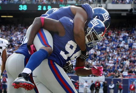 EAST RUTHERFORD, NJ - OCTOBER 11:  Mathias Kiwanuka #94 of the New York Giants celebrates after forcing a fumble against the Oakland Raiders with teammate Osi Umenyiora #72 on October 11, 2009 at Giants Stadium in East Rutherford, New Jersey. The Giants defeated the Raiders 44-7.  <br /><br /><span class="help">(Photo by Jim McIsaac/Getty Images)</span>