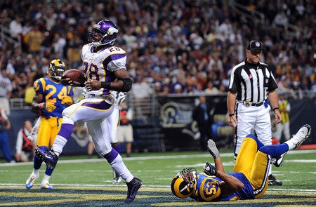 ST. LOUIS - OCTOBER 11:  Running back Adrian Peterson #28 of the Minnesota Vikings runs for a touchdown past Paris Lenon #53 of the St. Louis Rams at Edward Jones Dome on October 11, 2009 in St. Louis, Missouri.  <br /><br /><span class="help">(Photo by Ronald Martinez/Getty Images)</span>