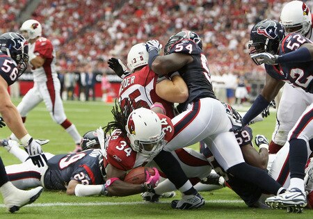 GLENDALE, AZ - OCTOBER 11:  Runningback Tim Hightower #34 of the Arizona Cardinals dives into the endzone to score a 1 yard rushing touchdown against the Houston Texans during the first quarter of the NFL game at the Universtity of Phoenix Stadium on October 11, 2009 in Glendale, Arizona.  <br /><br /><span class="help">(Photo by Christian Petersen/Getty Images)</span>