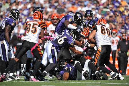 BALTIMORE - OCTOBER 11:  Bernard Scott #28 of the Cincinnati Bengals is tackled by the Baltimore Ravens defense at M&T Bank Stadium on October 11, 2009 in Baltimore, Maryland. The Bengals defeated the Ravens 17-14. <br /><br /><span class="help">(Photo by Larry French/Getty Images)</span>