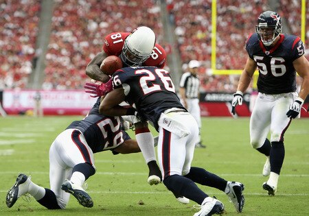 GLENDALE, AZ - OCTOBER 11:  Wide receiver Anquan Boldin #81 of the Arizona Cardinals has the ball knocked free after a reception by Eugene Wilson #26 of the Houston Texans during the first quarter of the NFL game at the Universtity of Phoenix Stadium on October 11, 2009 in Glendale, Arizona.  <br /><br /><span class="help">(Photo by Christian Petersen/Getty Images)</span>