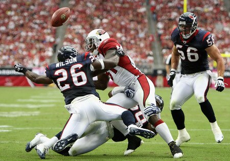 GLENDALE, AZ - OCTOBER 11:  Wide receiver Anquan Boldin #81 of the Arizona Cardinals has the ball knocked free after a reception by Eugene Wilson #26 of the Houston Texans during the first quarter of the NFL game at the Universtity of Phoenix Stadium on October 11, 2009 in Glendale, Arizona.  <br /><br /><span class="help">(Photo by Christian Petersen/Getty Images)</span>