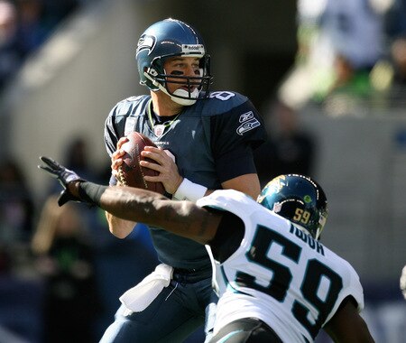 SEATTLE - OCTOBER 11:  Quarterback Matt Hasselbeck #8 of the Seattle Seahawks drops back to pass under pressure from Brian Iwuh #59 of the Jacksonville Jaguars on October 11, 2009 at Qwest Field in Seattle, Washington. <br /><br /><span class="help">(Photo by Otto Greule Jr/Getty Images)</span>