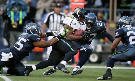 SEATTLE - OCTOBER 11:  Running back Maurice Jones-Drew #32 of the Jacksonville Jaguars rushes against Darryl Tapp #55 and Jordan Babineaux #27 of the Seattle Seahawks on October 11, 2009 at Qwest Field in Seattle, Washington. The Seahawks defeated the Jaguars 41-0. <br /><br /><span class="help">(Photo by Otto Greule Jr/Getty Images)</span>