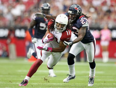 GLENDALE, AZ - OCTOBER 11: Wide receiver Larry Fitzgerald #11 of the Arizona Cardinals runs with the ball after a reception past Dunta Robinson #23 of the Houston Texans during the NFL game at the Universtity of Phoenix Stadium on October 11, 2009 in Glendale, Arizona. <br /><br /><span class="help">(Photo by Christian Petersen/Getty Images)</span>