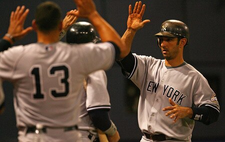 MINNEAPOLIS - OCTOBER 11: Jorge Posada #20 of the New York Yankees is greeted by teammates including Alex Rodriguez #13, after hitting a solo home run in the 7th inning against the Minnesota Twins in Game Three of the ALDS during the 2009 MLB Playoffs at the Hubert H. Humphrey Metrodome on October 11, 2009 in Minneapolis, Minnesota. <br /><br /><span class="help">(Photo by Jonathan Daniel/Getty Images)</span>