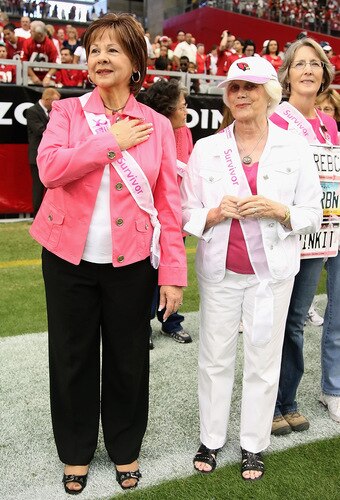 GLENDALE, AZ - OCTOBER 11: Glendale Mayor Elaine Scruggs and Nancy Bidwell, both cancer survivors, stand together during the singing of the National Anthem before the NFL game between the Arizona Cardinals and the Houston Texans at the Universtity of Phoenix Stadium on October 11, 2009 in Glendale, Arizona. <br /><br /><span class="help">(Photo by Christian Petersen/Getty Images)</span>