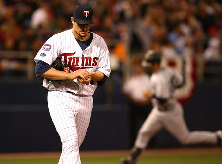 MINNEAPOLIS - OCTOBER 11: Carl Pavano #48 of the Minnesota Twins reacts as Jorge Posada #20 of the New York Yankees runs the bases after hitting a solo home run in the 7th inning in Game Three of the ALDS during the 2009 MLB Playoffs at the Hubert H. Humphrey Metrodome on October 11, 2009 in Minneapolis, Minnesota. <br /><br /><span class="help">(Photo by Jonathan Daniel/Getty Images)</span>