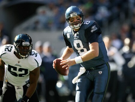 SEATTLE - OCTOBER 11:  Quarterback Matt Hasselbeck #8 of the Seattle Seahawks scrambles against linebacker Daryl Smith #52 of the Jacksonville Jaguars on October 11, 2009 at Qwest Field in Seattle, Washington. The Seahawks defeated the Jaguars 41-0. <br /><br /><span class="help">(Photo by Otto Greule Jr/Getty Images)</span>