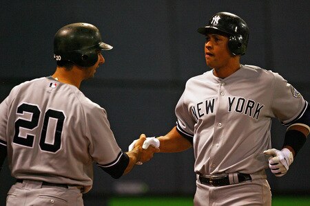 MINNEAPOLIS - OCTOBER 11: Alex Rodriguez #13 of the New York Yankees shakes hands with Jorge Posada #20 after hitting a solo home run in the 7th inning against the Minnesota Twins in Game Three of the ALDS during the 2009 MLB Playoffs at the Hubert H. Humphrey Metrodome on October 11, 2009 in Minneapolis, Minnesota. <br /><br /><span class="help">(Photo by Jonathan Daniel/Getty Images)</span>