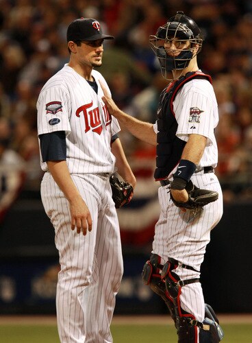 MINNEAPOLIS, MN - OCTOBER 11: Pitcher Carl Pavano #48 of the Minnesota Twins talks with catcher Joe Mauer #2 after Jorge Posada  the New York Yankees hit a home run in the seventh inning to take a 2-1 lead in Game Three of the ALDS during the 2009 MLB Playoffs at the Hubert H. Humphrey Metrodome on October 11, 2009 in Minneapolis, Minnesota. <br /><br /><span class="help">(Photo by Genevieve Ross/Getty Images)</span>