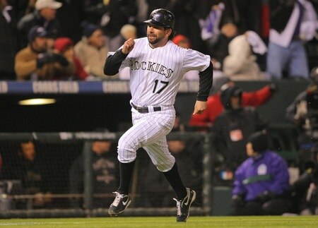 DENVER - OCTOBER 11:  Todd Helton #17 of the Colorado Rockies heads home as he scores on a RBI single in the bottom of the first inning by Garrett Atkins #27 against the Philadelphia Phillies in Game Three of the NLDS during the 2009 MLB Playoffs at Coors Field on October 11, 2009 in Denver, Colorado.  <br /><br /><span class="help">(Photo by Doug Pensinger/Getty Images)</span>