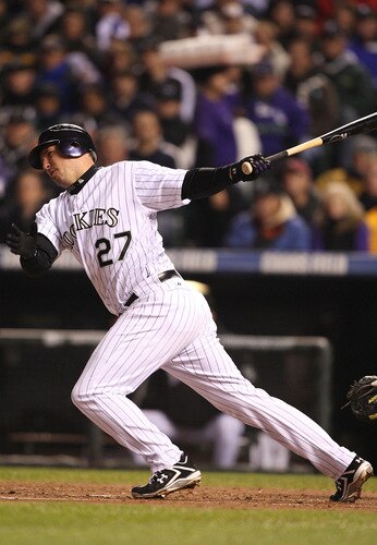 DENVER - OCTOBER 11:  Garrett Atkins #27 of the Colorado Rockies hits an rbi single against the Philadelphia Phillies in Game Three of the NLDS during the 2009 MLB Playoffs at Coors Field on October 11, 2009 in Denver, Colorado.  <br /><br /><span class="help">(Photo by Jed Jacobsohn/ Getty Images)</span>