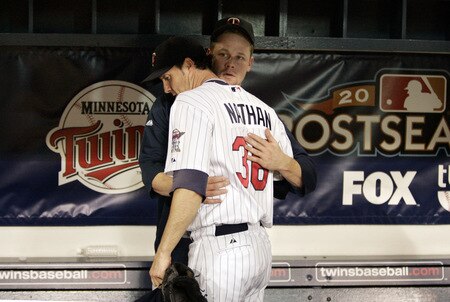 MINNEAPOLIS, MN - OCTOBER 11: Pitcher Joe Nathan #36 of the Minnesota Twins is comforted by teammate Justin Morneau after being defeated by the New York Yankees in Game Three of the ALDS during the 2009 MLB Playoffs at the Hubert H. Humphrey Metrodome on October 11, 2009 in Minneapolis, Minnesota. <br /><br /><span class="help">(Photo by Genevieve Ross/Getty Images)</span>