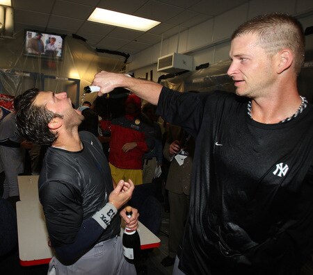 MINNEAPOLIS - OCTOBER 11: A.J. Burnett (R) of the New York Yankees pours champagne into the mouth of Nick Swisher after a win over the Minnesota Twins in Game Three of the ALDS during the 2009 MLB Playoffs at the Hubert H. Humphrey Metrodome on October 11, 2009 in Minneapolis, Minnesota. <br /><br /><span class="help">(Photo by Jonathan Daniel/Getty Images)</span>