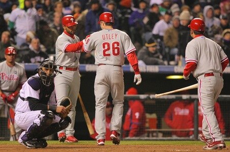 DENVER - OCTOBER 11:  Chase Utley #26 of the Philadelphia Phillies is congratulated by teammate Pedro Feliz #7 after he was forced home and score on a walk by Raul Ibanez #29 in the top of the fourth inning against the Colorado Rockies in Game Three of the NLDS during the 2009 MLB Playoffs at Coors Field on October 11, 2009 in Denver, Colorado. <br /><br /><span class="help">(Photo by Doug Pensinger/Getty Images)</span>