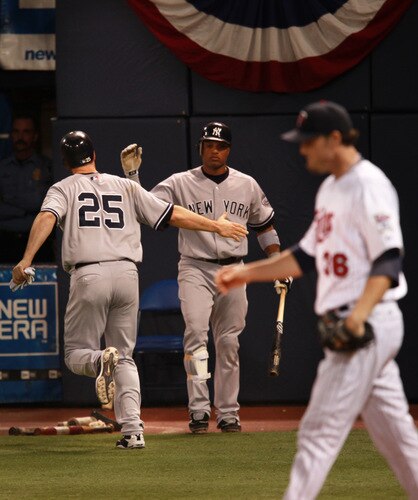 MINNEAPOLIS, MN - OCTOBER 11: Mark Teixeira #25 of the New York Yankees celebrates with teammate Robinson Cano #24 after scoring a run against Joe Nathan #36 of the Minnesota Twins in the ninth inning in Game Three of the ALDS during the 2009 MLB Playoffs at the Hubert H. Humphrey Metrodome on October 11, 2009 in Minneapolis, Minnesota. The Yankees defeated the Twins 4-1. <br /><br /><span class="help">(Photo by Genevieve Ross/Getty Images)</span>