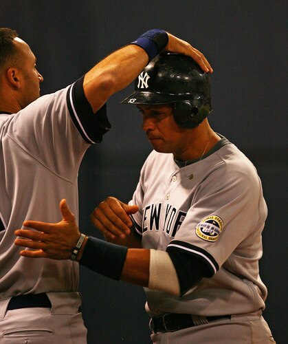 MINNEAPOLIS - OCTOBER 11: Alex Rodriguez #13 of the New York Yankees gets a pat on the head from teammate Derek Jeter #2 after scoring a run against the Minnesota Twins in Game Three of the ALDS during the 2009 MLB Playoffs at the Hubert H. Humphrey Metrodome on October 11, 2009 in Minneapolis, Minnesota. <br /><br /><span class="help">(Photo by Jonathan Daniel/Getty Images)</span>