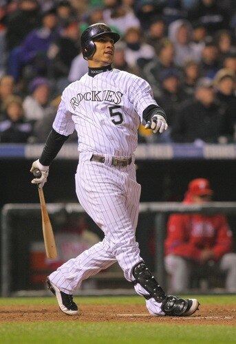 DENVER - OCTOBER 11:  Carlos Gonzalez #5 of the Colorado Rockies hits a solo home run against the Philadelphia Phillies in the bottom of the fourth inning in Game Three of the NLDS during the 2009 MLB Playoffs at Coors Field on October 11, 2009 in Denver, Colorado.  <br /><br /><span class="help">(Photo by Doug Pensinger/ Getty Images)</span>