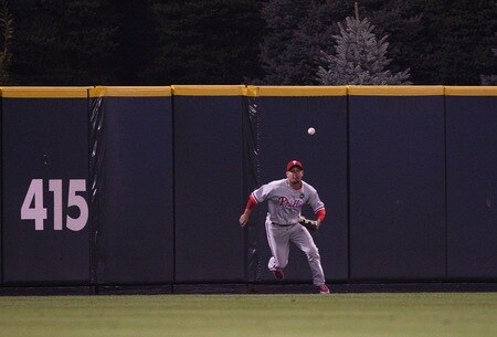 DENVER - OCTOBER 11:  Shane Victorino #8 of the Philadelphia Phillies fields a RBI double by Garrett Atkins #27 of the Colorado Rockies in the bottom of the third inning in Game Three of the NLDS during the 2009 MLB Playoffs at Coors Field on October 11, 2009 in Denver, Colorado. <br /><br /><span class="help">(Photo by Jed Jacobsohn/Getty Images)</span>