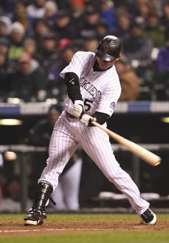 DENVER - OCTOBER 11:  Carlos Gonzalez #5 of the Colorado Rockies doubles against the Philadelphia Phillies to lead off the bottom of the seventh inning in Game Three of the NLDS during the 2009 MLB Playoffs at Coors Field on October 11, 2009 in Denver, Colorado.  <br /><br /><span class="help">(Photo by Jed Jacobsohn/ Getty Images)</span>