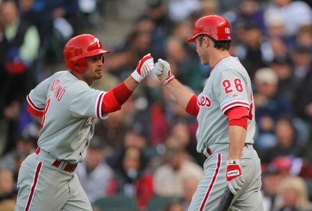 DENVER - OCTOBER 11:  Shane Victorino #8 (L) of the Philadelphia Phillies bumps fists with teammate Chase Utley #26 after Victorino's solo home run in the top of the first inning against the Colorado Rockies in Game Four of the NLDS during the 2009 MLB Playoffs at Coors Field on October 12, 2009 in Denver, Colorado. <br /><br /><span class="help">(Photo by Doug Pensinger/Getty Images)</span>