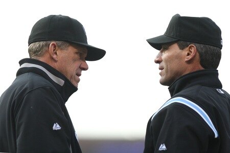 DENVER - OCTOBER 11:  Manager Jim Tracy #4 of the Colorado Rockies discusses a fielder's choice call with first base umpire Angel Hernandez #55 against the Philadelphia Phillies in Game Four of the NLDS during the 2009 MLB Playoffs at Coors Field on October 12, 2009 in Denver, Colorado.  <br /><br /><span class="help">(Photo by Jed Jacobsohn/ Getty Images)</span>